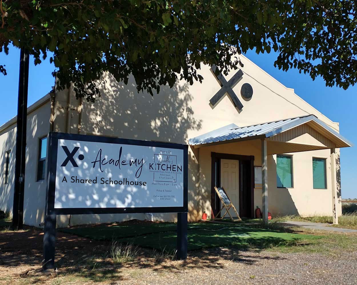 The original X• schoolhouse in Noodle, Texas — where it started in 2023